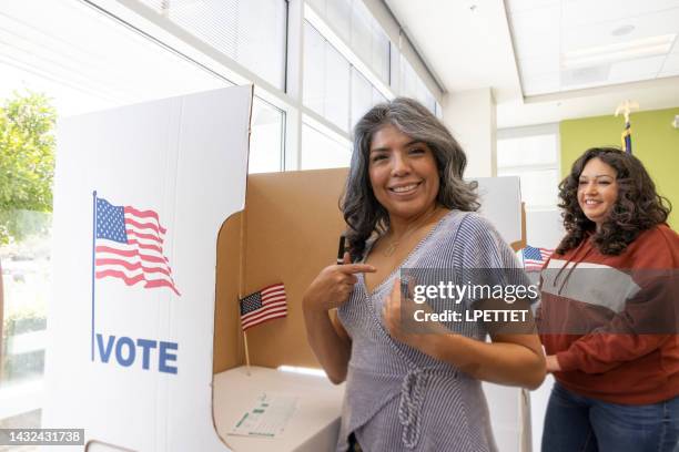 voting - woman voting stock pictures, royalty-free photos & images