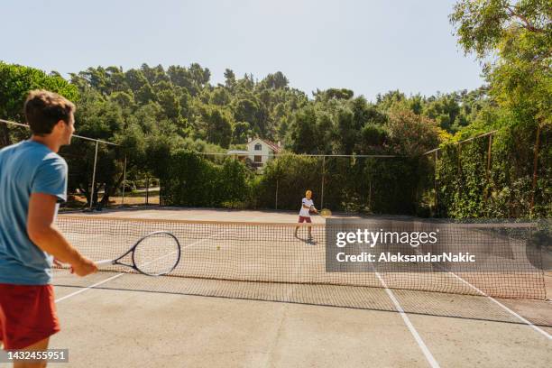 practicing tennis with my dad - tennis adult stock pictures, royalty-free photos & images