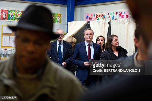 The Debout la République party's candidate for the 2012 French presidential election Nicolas Dupont-Aignan holds the line prior to casting his ballot...