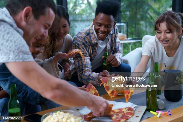 yummy pizza party with friends at home - sharing pizza stock pictures, royalty-free photos & images