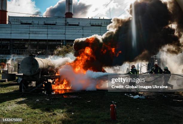 Firefighters work to put out a fire at CHP power station hit by Russian missile on October 10, 2022 in Kyiv, Ukraine. The aerial threat in the...