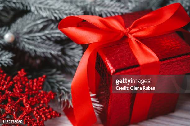 red gift box and snowflake near coniferous branches. - jewellery gift stock pictures, royalty-free photos & images