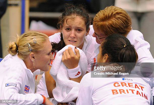 Laura Robson of Great Britain is consoled by team mates Elena Baltacha, Heather Watson and captain Judy Murray after losing her match against Sofia...