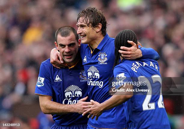 Nikica Jelavic of Everton celebrates scoring the opening goal with team mates Darron Gibson and Steven Pienaar during the Barclays Premier League...