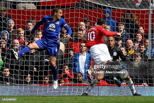 Wayne Rooney of Manchester United scores his team's first goal during the Barclays Premier League match between Manchester United and Everton at Old...