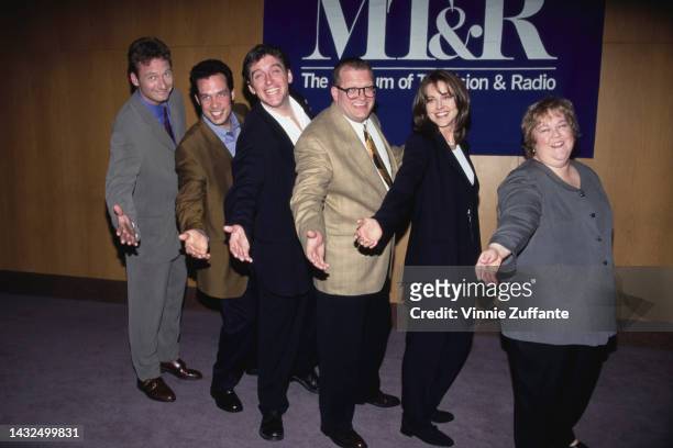 Drew Carey poses with others next to a sign that reads "MT&R The Museum of Television and Radio" in Los Angeles, United States, cirac 1991.