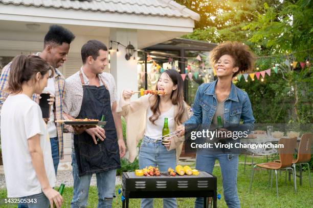 group of people party barbecue grill at backyard - backyard grilling stockfoto's en -beelden