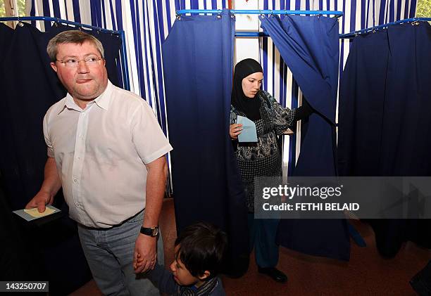French citizen living in Tunisia leaves a polling booth prior to casting her vote on April 22, 2012 for the first round of the 2012 French...