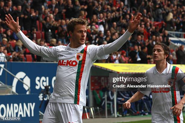 Sebastian Langkamp of Augsburg celebrates scoring the opening goal with his team mate Paul Verhaegh during the Bundesliga match between FC Augsburg...