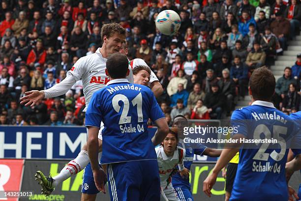 Sebastian Langkamp of Augsburg scores the opening goal during the Bundesliga match between FC Augsburg and FC Schalke 04 at SGL Arena on April 22,...