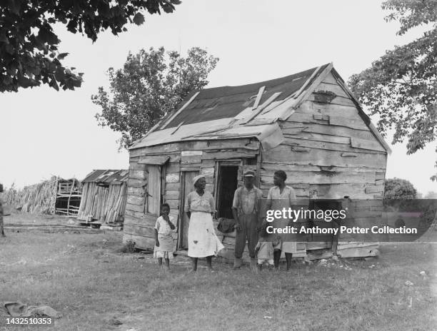 American sharecropper Lewis Hunter with his wife and family outside their accommodation on Lady's Island, an island in Beaufort County, South...