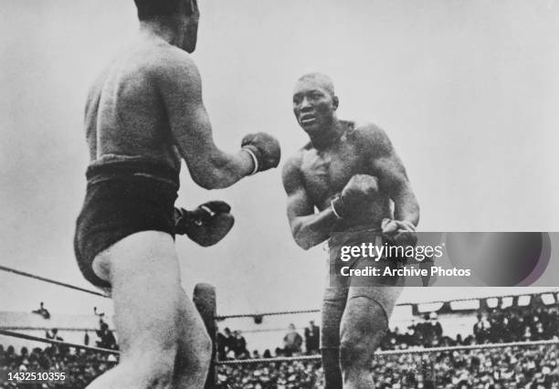 Canadian boxer Tommy Burns in action against American boxer Jack Johnson in their world heavyweight title fight at the Sydney Stadium in Sydney,...