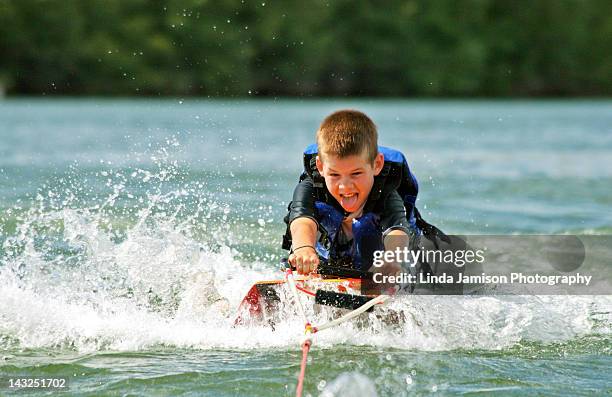 boy at knee boarding - waterskiing stock pictures, royalty-free photos & images