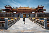 Young man at the gates of the imperial city of Hue, Vietnam.