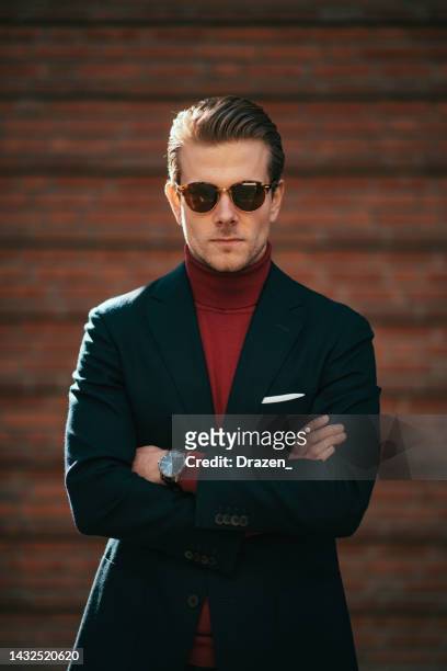 portrait of millennial handsome businessman during - red blazer stock pictures, royalty-free photos & images