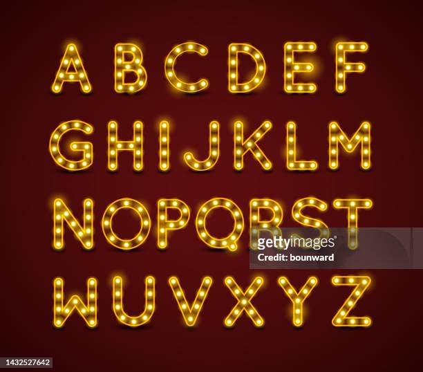 light bulb alphabet with gold frame on dark red background. - fashion show vector stock illustrations