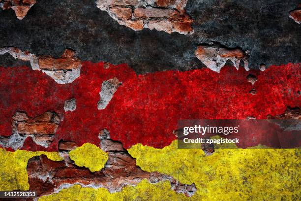 german flag on damaged wall - deutsche flagge stock-fotos und bilder