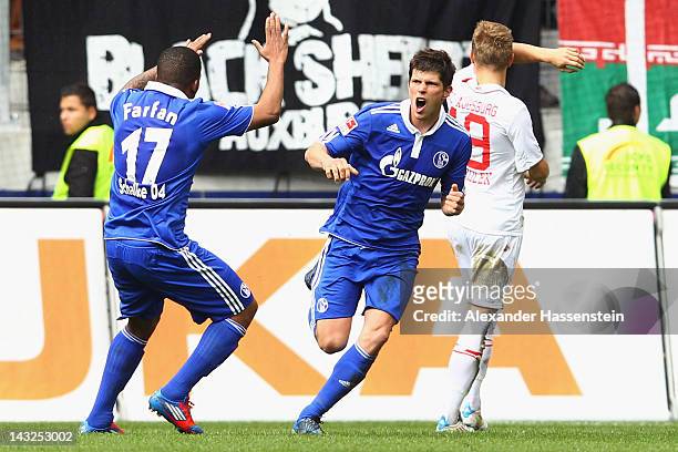 Klaas-Jan Huntelaar of Schalke celebrates scoring the first team goal with his team mate Jefferson Farfan during the Bundesliga match between FC...