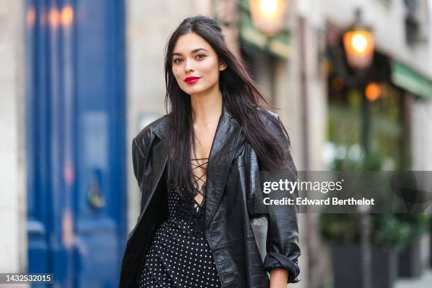 Guest wears a black laces chest top, a black shiny leather crocodile print pattern blazer jacket, a black shiny leather crocodile print pattern...