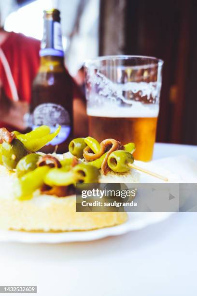 spanish tapa and a beer - anchovy fotografías e imágenes de stock