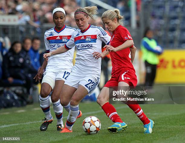 Elodie Thomis, Camille Abily and Bianca Schmidt battle for the ball during the second UEFA Women's Champions League semi final match between Turbine...