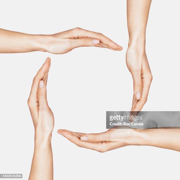 united hands - four people holding hands stock pictures, royalty-free photos & images