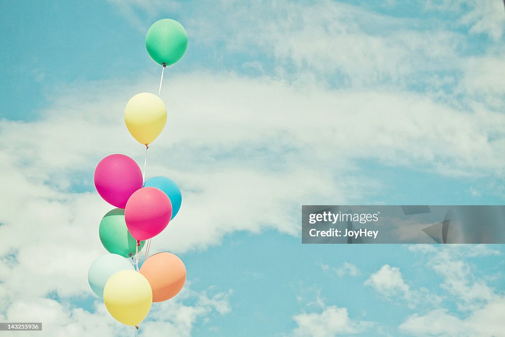 Balloons in against sky