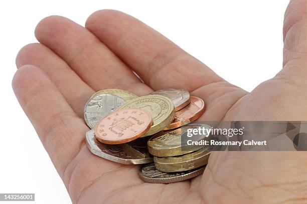 selection of uk coins in outstretched hand - british coin stock pictures, royalty-free photos & images