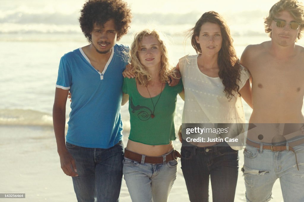 Group of youngsters walking on the beach