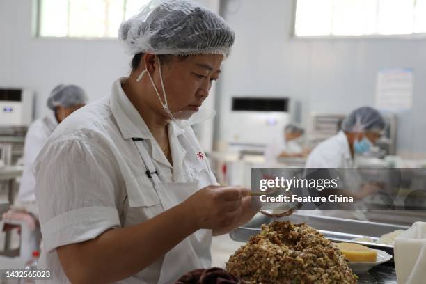 Workers make dumplings known as jiaozi in Chinese at a food processor in Huimin county in east China's Shandong province.