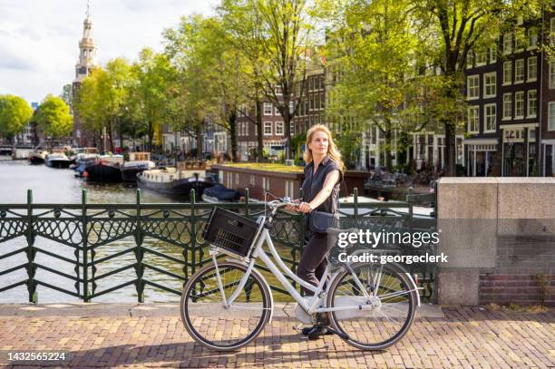 cyclist in amsterdam - amsterdam cycling stock pictures, royalty-free photos & images