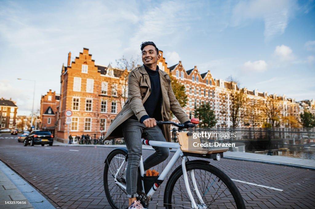 Millennial Asian tourist in the city with bicycle