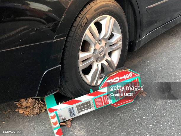 New York City car Boot on wheel, used when driver hasn't paid outstanding tickets, Queens, New York.