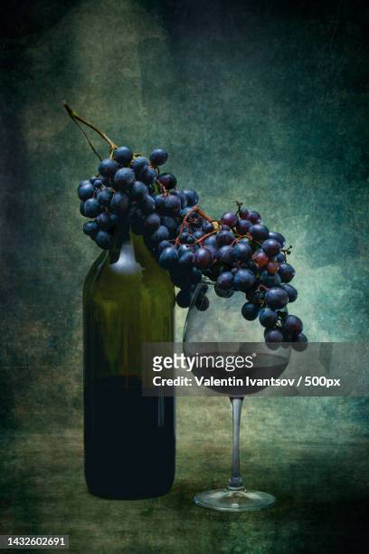glass of red wine and bunches of grapes - glass installer stock pictures, royalty-free photos & images
