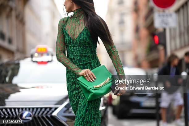 Guest wears a black tulle with embroidered green sequined turtleneck / long sleeves / long midi tube dress, a black V-neck tube dress, a green shiny...