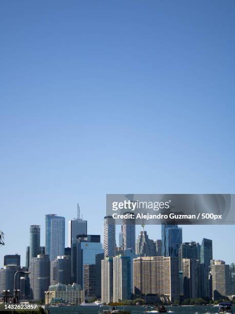 view of cityscape against clear blue sky,toronto,ontario,canada - day toronto stock pictures, royalty-free photos & images