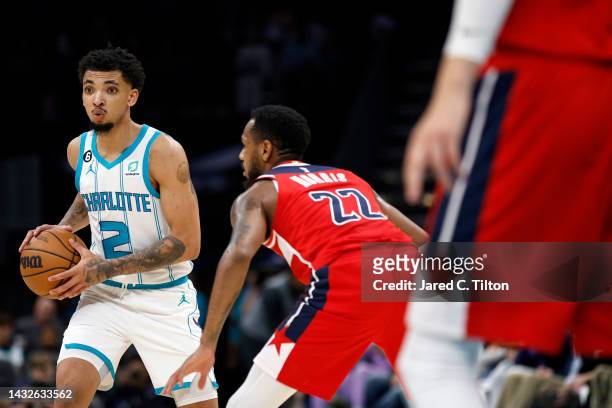 James Bouknight of the Charlotte Hornets looks to pass against Monte Morris of the Washington Wizards during the second quarter of the game at...