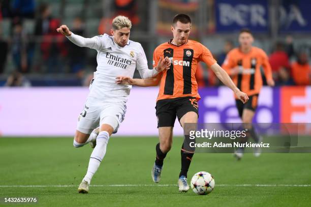 Bohdan Mykhailichenko of Shakhtar Donetsk is challenged by Federico Valverde of Real Madrid during the UEFA Champions League group F match between...