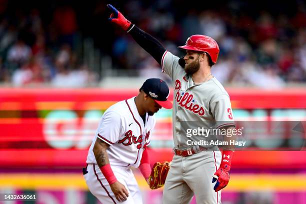 Bryce Harper of the Philadelphia Phillies reacts after hitting a double against the Atlanta Braves during the sixth inning in game one of the...