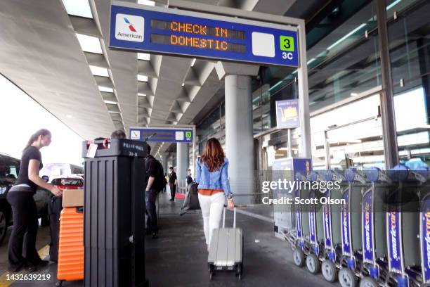 Passengers arrive for American Airlines flights at O'Hare International Airport on October 11, 2022 in Chicago, Illinois. Citing a strong summer...