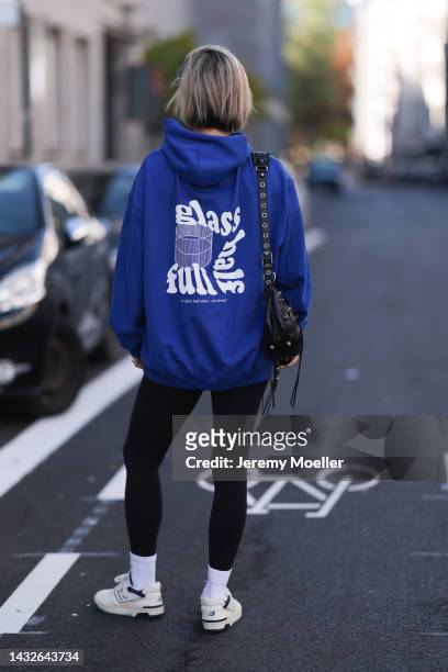 Victoria Thomas seen wearing a Balenciaga le cagole black leather bag, Lululemon leggings and a hernameis sweater on October 09, 2022 in Cologne,...
