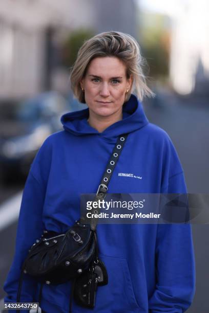 Victoria Thomas seen wearing a Balenciaga le cagole black leather bag and a hernameis sweater on October 09, 2022 in Cologne, Germany.