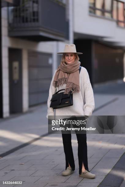 Victoria Thomas seen wearing Birkenstock shoes, H&M pants, a Black Palms sweater, an Acne Studios scarf, a beige hat and a Jacquemus black big bag on...