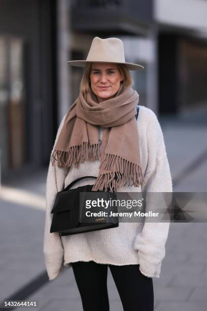 Victoria Thomas seen wearing H&M pants, Black Palms sweater, an Acne Studios scarf, a beige hat and a Jacquemus black big bag on October 09, 2022 in...