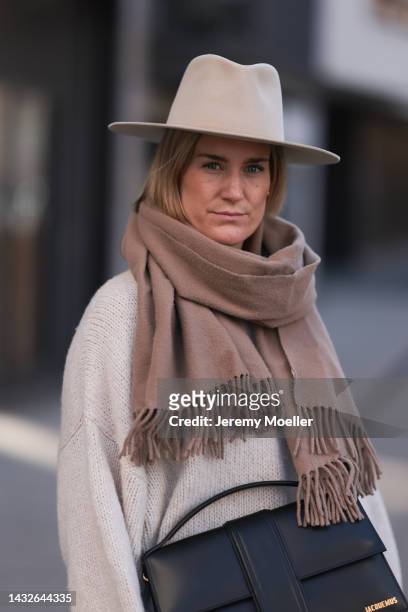 Victoria Thomas seen wearing a Black Palms sweater, an Acne Studios scarf, a beige hat and a Jacquemus black big bag on October 09, 2022 in Cologne,...