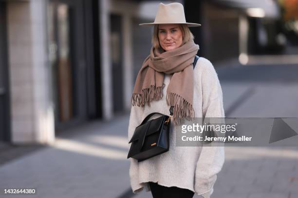 Victoria Thomas seen wearing a Black Palms sweater, an Acne Studios scarf, a beige hat and a Jacquemus black big bag on October 09, 2022 in Cologne,...