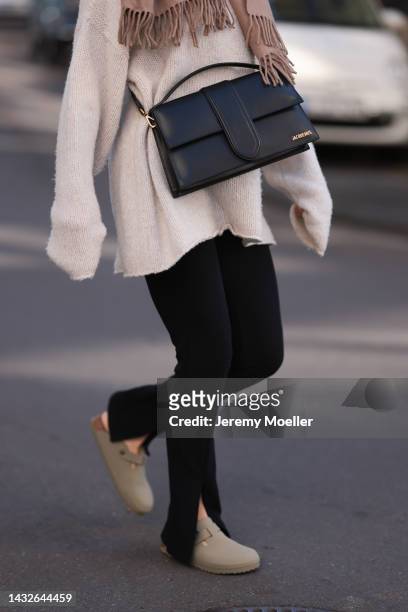 Victoria Thomas seen wearing Birkenstock shoes, H&M pants, a Black Palms sweater, an Acne Studios scarf and a Jacquemus black big bag on October 09,...
