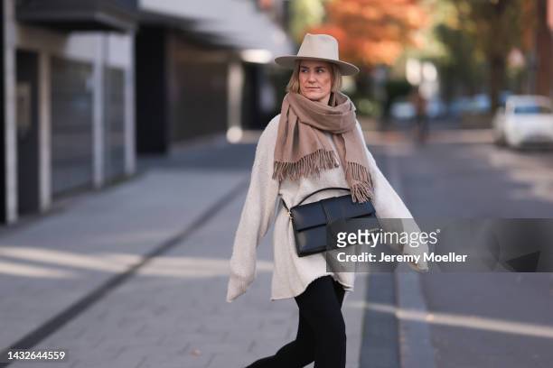 Victoria Thomas seen wearing H&M pants, a Black Palms sweater, an Acne Studios scarf, a beige hat and a Jacquemus black big bag on October 09, 2022...
