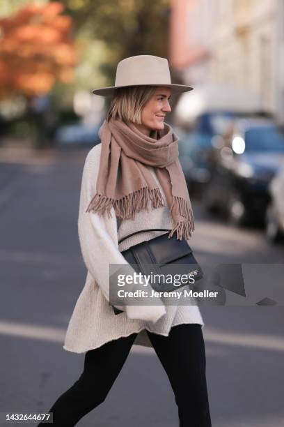 Victoria Thomas seen wearing H&M pants, a Black Palms sweater, an Acne Studios scarf, a beige hat and a Jacquemus black big bag on October 09, 2022...