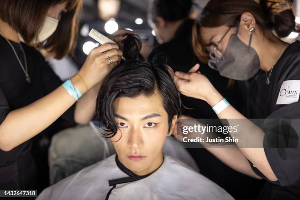 Model prepares backstage ahead of the SONGZIO runway show at Seoul Fashion Week SS 23 on October 11, 2022 in Seoul, South Korea.